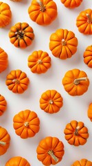 Top view of assorted decorative pumpkins on white background with unique patterns