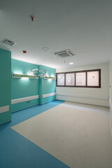 Vibrant empty hospital rooms with modern blue and grey flooring, radiating a calming yet professional atmosphere