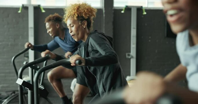 Fitness, people and fist bump for exercise bike challenge at gym with motivation, luck and cardio performance. Sports, club and friends with spinning class agreement, success or progress celebration