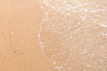 Yellow sand on the seashore as an abstract background. Texture