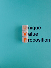 Concept orange words UVP, Unique Value Proposition on wooden cubes. Beautiful blue background....