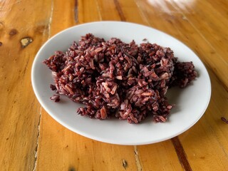 Rice. Rice without berries. Cooked rice. Rice without berries in a white plate. Invites you to eat, dark purple color, looks delicious.
