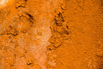 Saffron plastered brick wall texture. Saffron painted retro wall built structure. Grungy shabby uneven painted plaster. Abstract saffron wash background. Design element.