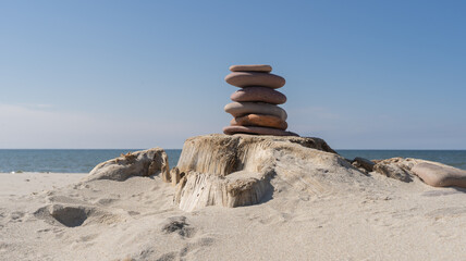 Zen concept. Sand and stack stones on dry log