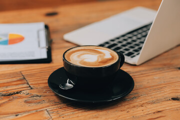 Closeup of coffee cup on table in empty corporate conference room before business meeting in office