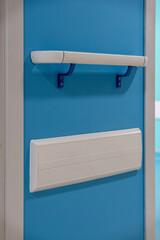 hospital White handrail mounted on a calming blue wall. Perfect for safety & navigation concepts