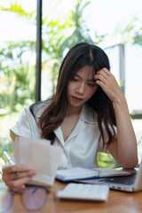 Woman working outside using calculator and laptop Attentive Asian woman checks taxes, rent, financial expenses to pay bills Control your finances online Accounting work concept.