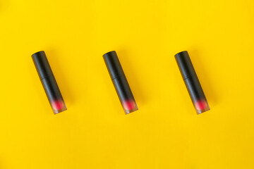 Close up of lip gloss, isolated on yellow background. 