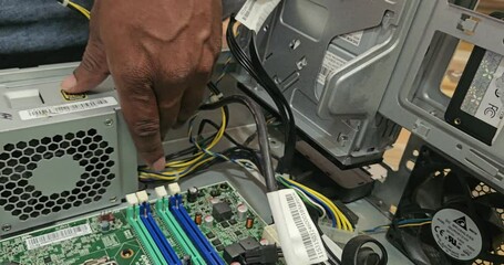 Electronics repair and maintenance service. technician working with computer parts.