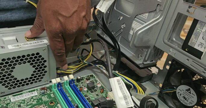 Electronics repair and maintenance service. technician working with computer parts.