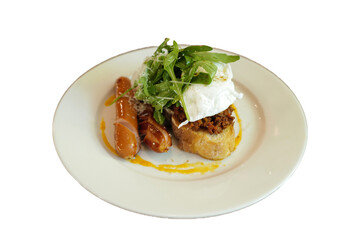 Isolated plate of bacon and rocket salad on toast served with sausage