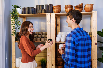 A couple of Caucasian male and Asian female sell vase products online at home. Checking vases stock together for send by order to the customers. Remote purchase, Shopping online concept.