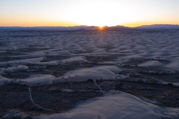 Texture of giant sand dunes and mountain range at sunset at the Little Sahara Recreation Area, Nephi, Utah, United States of America.