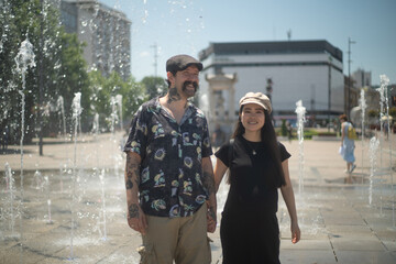 A young couple, a pregnant mother and a father portrayed in the city