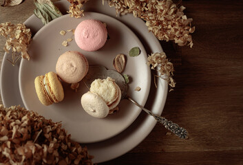 Delicious sweet colorful macaroons with dried flowers.