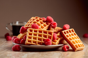 Belgian waffles with raspberries and black coffee.