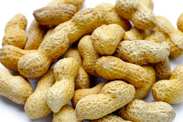 Roasted peanuts in shell on white background.