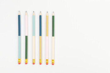 Top view of colorful pencils on white background. School, office, art wallpaper. Flat lay, copy space.