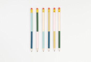 Fototapeta premium Top view of colorful pencils on white background. School, office, art wallpaper. Flat lay, copy space.