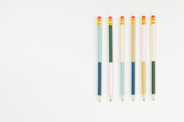 Top view of colorful pencils on white background. School, office, art wallpaper. Flat lay, copy space.