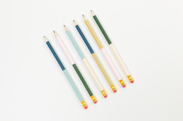Fototapeta premium Top view of colorful pencils on white background. School, office, art wallpaper. Flat lay, copy space.