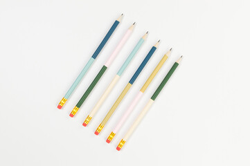 Top view of colorful pencils on white background. School, office, art wallpaper. Flat lay, copy space.