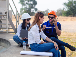 Group of engineers and architects working on the basis of a wind turbine Inspect the structure with...