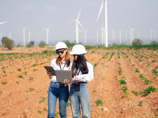 Group of architects working on the basis of a wind turbine Check area structure and wind turbines