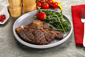 Grilled chuck roll steak with arugula