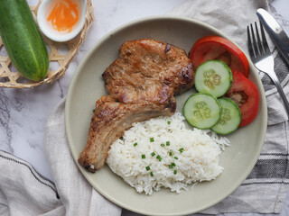 Grilled Pork Chop over rice - Vietnamese food called Suon Nuong at top view 