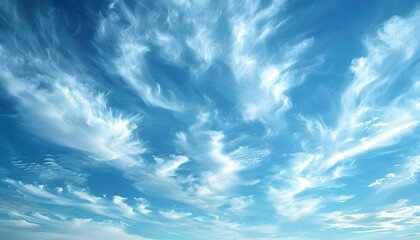 A bright blue sky with wispy white clouds.