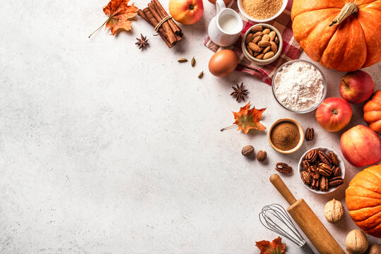 Autumn baking background with pumpkins, apples, nuts