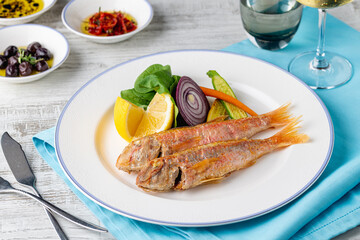 Top view of raw red mullet fish on ice on display at seafood fish market