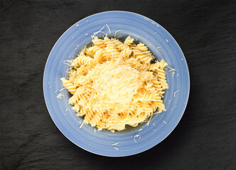 Pasta with Grated Cheese on Blue Plate