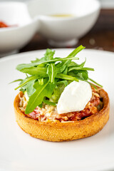 Italian dish Tortino di Verdure served on a white plate on wooden table