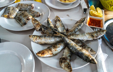 Fried sardines on Moroccan street restaurant. Tasteless tourists food, popular local cuisine