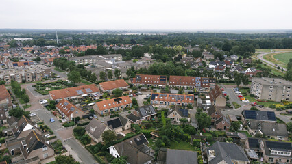 Obraz premium Aerial shot of houses with solar panels on roof in a street in a residential area neighborhood in Steenwijk, Overijssel, The Netherlands.