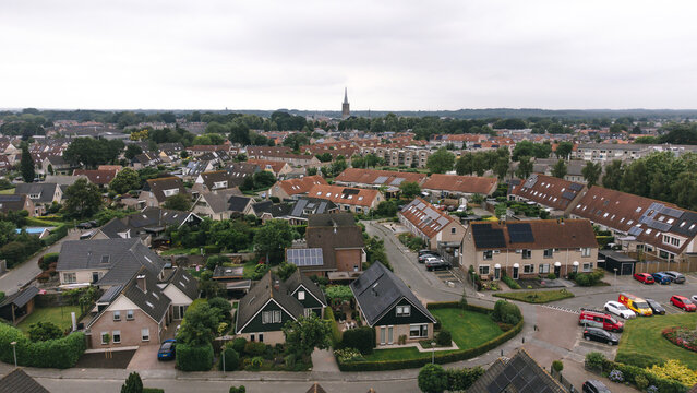 Aerial shot of houses with solar panels on roof in a street in a residential area neighborhood in Steenwijk, Overijssel, The Netherlands.