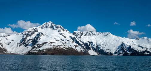Snow covered mountains in late spring on the shores of resurrection Bay, Kenai Fjords National Park, Seward, Alaska, USA