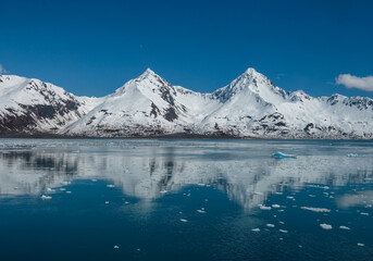 Reflection of two beautiful mountain peaks on the shores of Aialik Bay, Kenai Fjords National Park, Seward, Alaska, USA