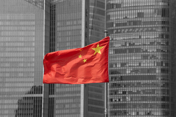 chinese flag in front of skyscraper