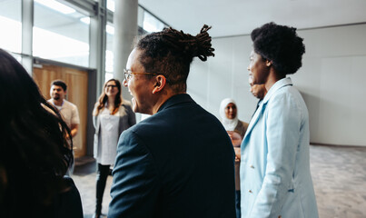 Diverse group of professionals networking at a modern business event