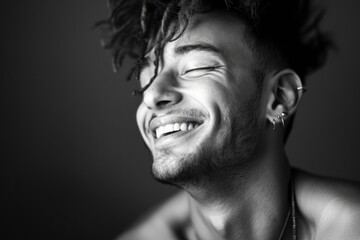 A happy individual with dreadlocks, smiling at the camera