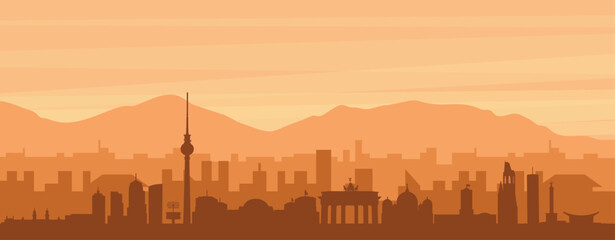 Brown panoramic poster of the city skyline with misty background buildings, sunrise, clouds and mountains of BERLIN, GERMANY