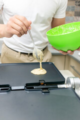 Young smiling happy confident  baker man  in the kitchen. Process cooking food concept. 