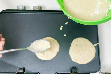 Young smiling happy confident  baker man  in the kitchen. Process cooking food concept. 