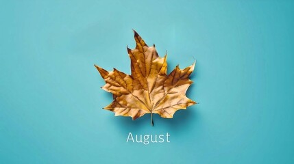 Single autumn leaf against a blue background with the word "August," symbolizing the transition from summer to fall.
