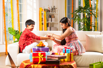 Indian brother and sister enjoying togetherness while celebrating rakhi, rakshabandhan or bhai dooj