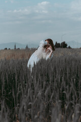 Young woman dancing outdoors. Modern dance performance in the meadow field. Carefree and freedom in...