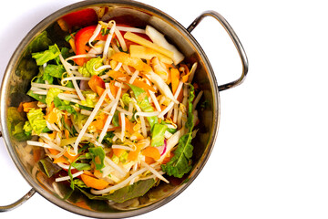 Stir fry mixture -mixed vegetables with bamboo shoots and water chestnuts in wok. Top view.
